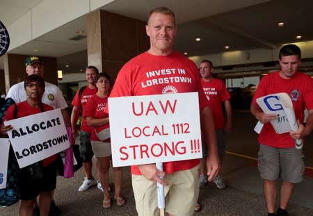 An auto worker from the General Motors Lordstown assembly plant stops to be photographed while protesting GM plant closings outside General Motors World Headquarters in Detroit,