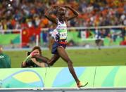 2016 Rio Olympics - Athletics - Final - Men's 10,000m Final - Olympic Stadium - Rio de Janeiro, Brazil - 13/08/2016. Mo Farah (GBR) of Britain reacts after winning. REUTERS/Leonhard Foeger