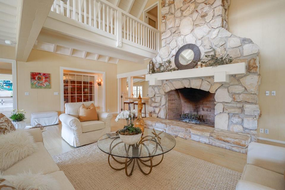 The large living room features a Carmel stone fireplace.