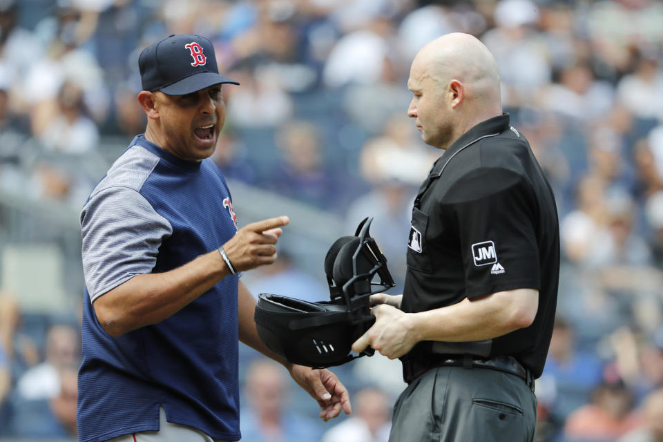 Boston Red Sox manager Alex Cora, left, reacts to umpire Mike Estabrook during a baseball game against the New York Yankees in the fourth inning, Saturday, Aug. 3, 2019, in New York. (AP Photo/Michael Owens)