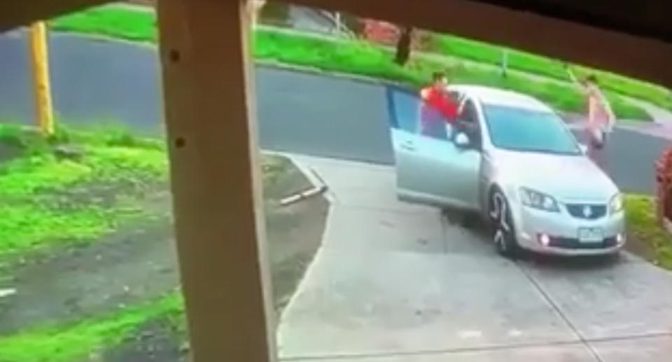 Two men are pictured fighting back against two alleged intruders trying to make a getaway in a car.