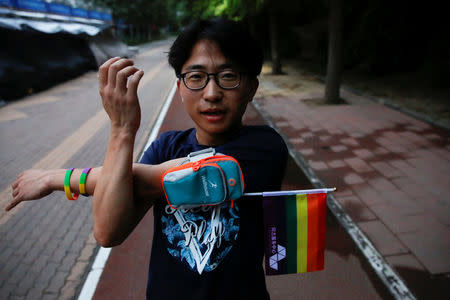 A participant warms up for a 5.17 km run to mark International Day Against Homophobia in a park in Beijing, China, May 17, 2018. REUTERS/Thomas Peter