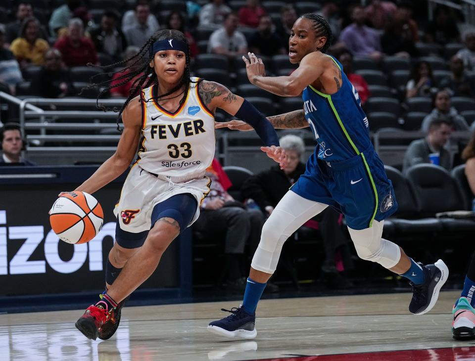 Indiana Fever guard Destanni Henderson (33) rushes up the court against Minnesota Lynx Yvonne Turner (22) on Tuesday, May 10, 2022, at Gainbridge Fieldhouse in Indianapolis. 