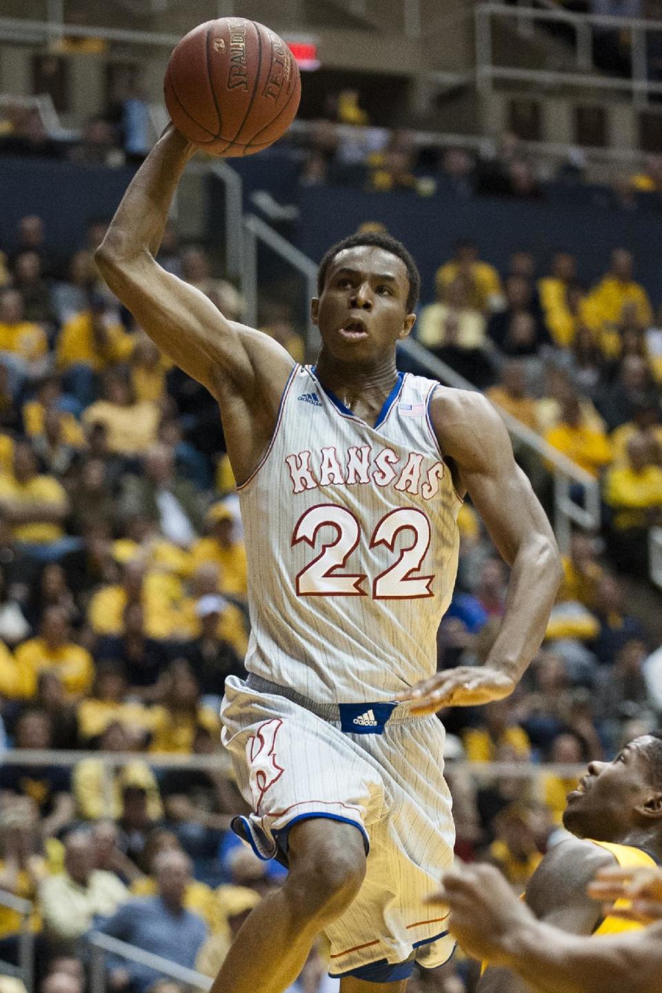 Kansas' Andrew Wiggins (22) drives to the basket during the first half of an NCAA college basketball game against West Virginia, Saturday, March 8, 2014, in Morgantown, W.Va. (AP Photo/Andrew Ferguson)