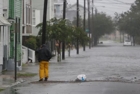 A man checks on flooding around his home along Aiken Street during Hurricane Dorian in Charleston,