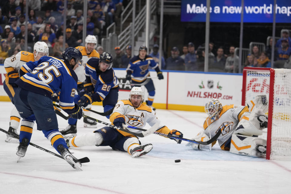 St. Louis Blues center Jordan Kyrou (25) is unable to score past Nashville Predators goaltender Kevin Lankinen (32) and Ryan McDonagh (27) during the second period of an NHL hockey game on Friday, Nov. 24, 2023, in St. Louis. (AP Photo/Jeff Roberson)