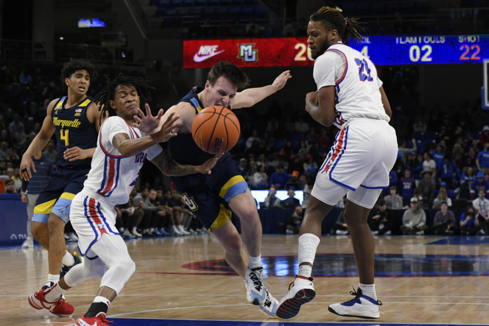 Marquette's Tyler Kolek (11) battles DePaul's Jalen Terry (3) and Da' Sean Nelson (21) for a loose ball during the first half of an NCAA college basketball game Wednesday, Jan. 24, 2024, in Chicago. (AP Photo/Paul Beaty)