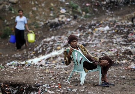 A Muslim man, whose home was burnt in 2013 during anti-Muslim violence and unrest, sits on a chair at Thiriminglar quarter in Meiktila May 15, 2015. REUTERS/Soe Zeya Tun