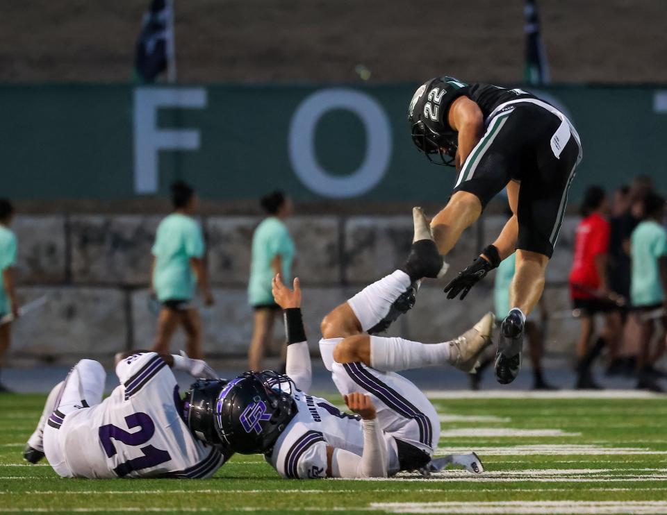 Cedar Park's Garrett Nichols vaults over Cedar Ridge defenders during the Timberwolves' 29-7 win Friday night at Gupton Stadium.