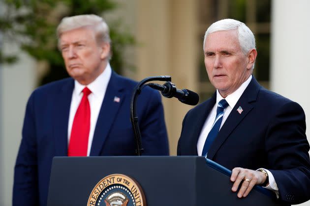 President Donald Trump listens as Vice President Mike Pence speaks about the coronavirus in the Rose Garden of the White House, April 27, 2020, in Washington.