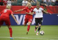 Jul 4, 2015; Edmonton, Alberta, CAN; England defender Alex Greenwood (14) and Germany midfielder Simone Laudehr (6) chase a ball in the second half during the third place match of the FIFA 2015 Women's World Cup at Commonwealth Stadium. Erich Schlegel-USA TODAY Sports