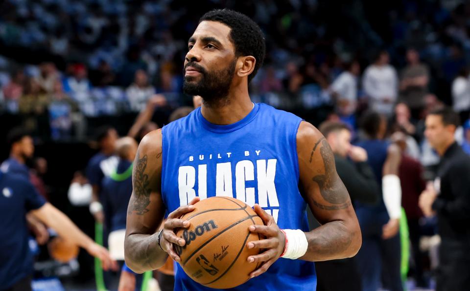 Dallas guard Kyrie Irving warms up before the game against Minnesota at American Airlines Center.