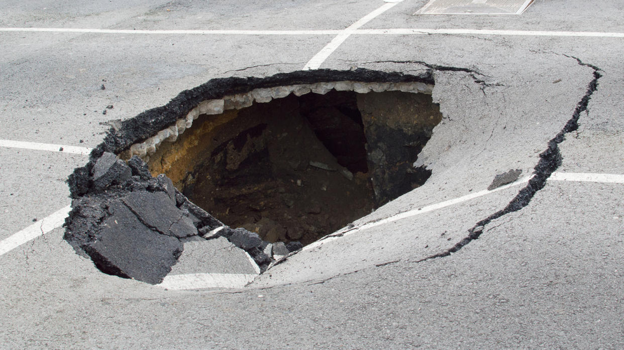 A hole 2-3 feet deep in the middle of a parking lot