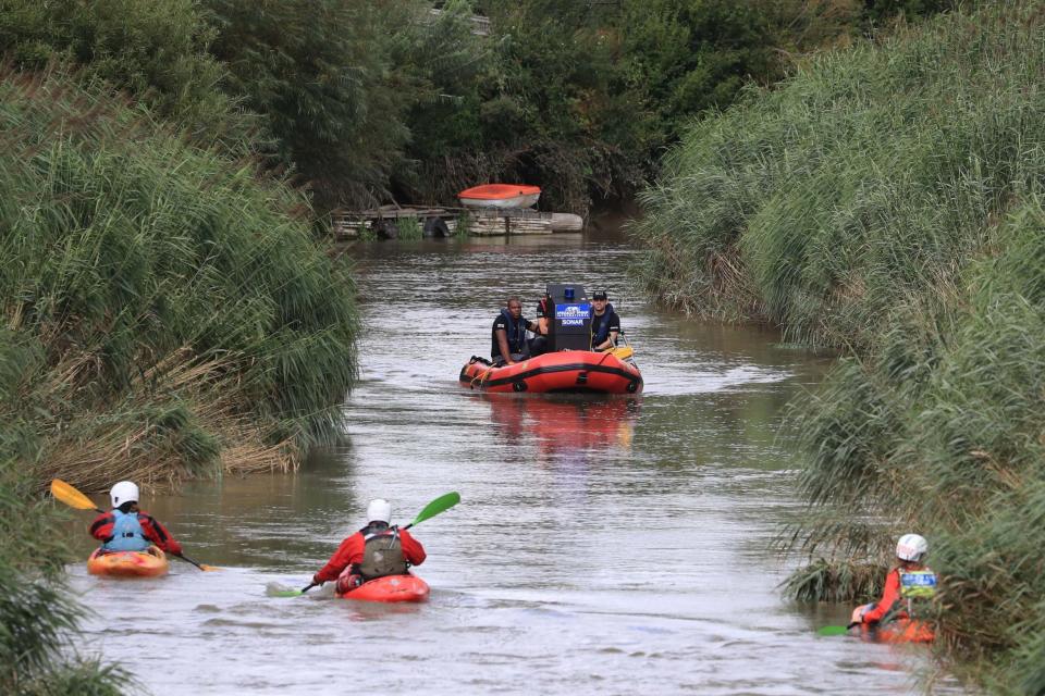 Specialist search groups search a section of the River Stour for missing six-year-old Lucas Dobson (PA)