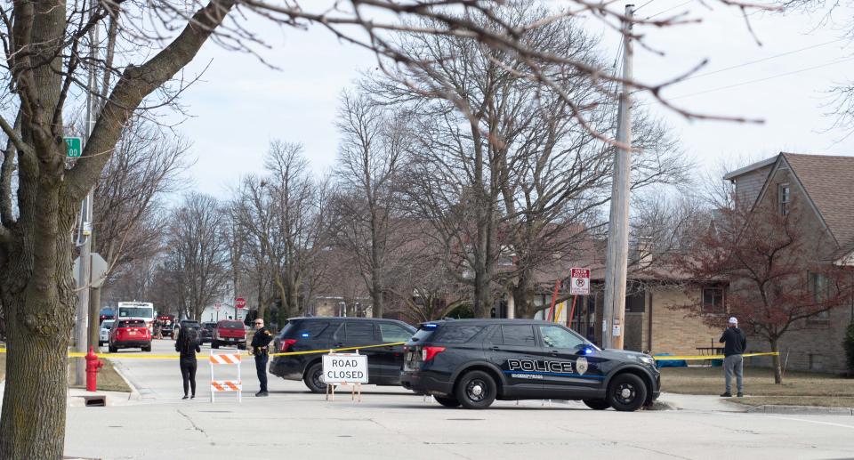 The area near the 2700 block of South Ninth Street is marked off by police officers at approximately 1:50 p.m. Wednesday. Emergency responders can be see in the background as onlookers observe from behind police tape.