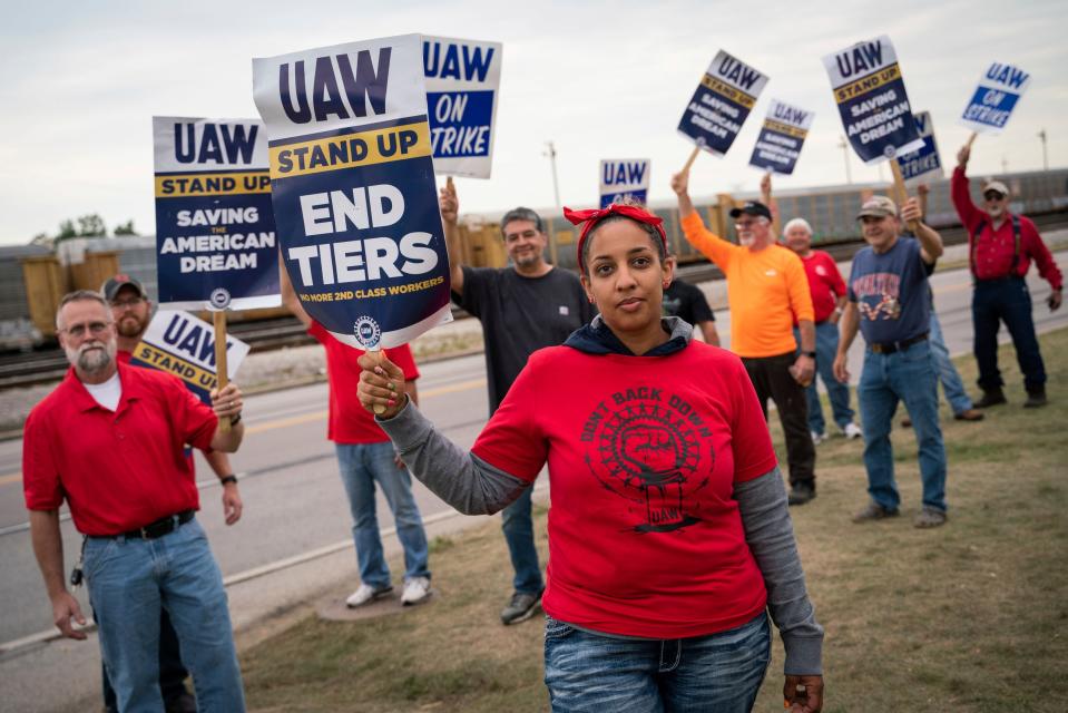 Erika Mitchell, 36, of Toledo, Ohio, center, stands with skilled trade workers for gate 7 during a UAW strike outside of the Chrysler Toledo Assembly Plant in Toledo, Ohio on Tuesday, Sept. 19, 2023.