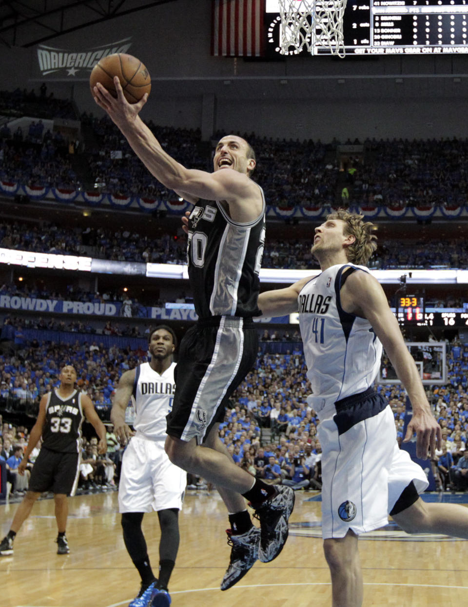 San Antonio Spurs' Manu Ginobili (20) goes up for a shot as Dallas Mavericks' Dirk Nowitzki (41) defends in the first half of Game 4 of an NBA basketball first-round playoff series, Monday, April 28, 2014, in Dallas. (AP Photo/Tony Gutierrez)