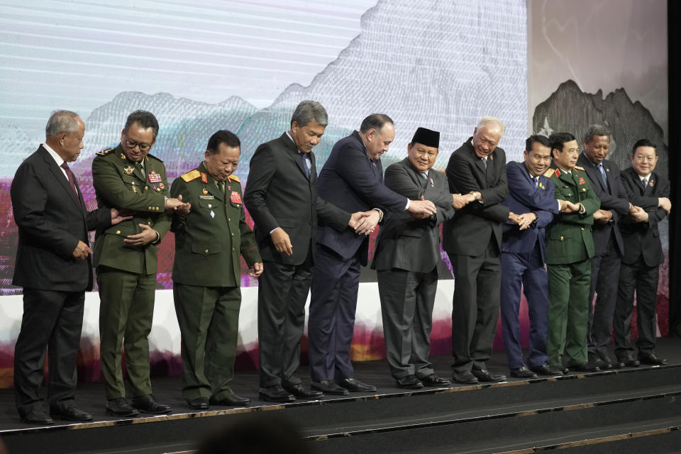 From left, Brunei's Second Minister of Defense Halbi Mohd Yusof, Cambodia's Defense Minister Tea Seiha, Laos' Defense Minister Chansamone Chanyalath, Malaysia's Defense Minister Mohamad Hasan, Philippine's Defense Secretary Gilbert Teodoro, Indonesia's Defense Minister Prabowo Subianto, Singapore's Defense Minister Ng Eng Hen, Thailand's Defense Minister Sutin Klungsang, Vietnam's Defense Minister Phan Van Giang, East Timor's Defense Minister Donaciano Do Rosario Da Costa Gomes and ASEAN Secretary General Kao Kim Hourn hold hands as they pose for a family photo during the Association of Southeast Asian Nations (ASEAN) Defense Ministers Meeting in Jakarta, Indonesia, Wednesday, Nov. 15, 2023. (AP Photo/Dita Alangkara, Pool)
