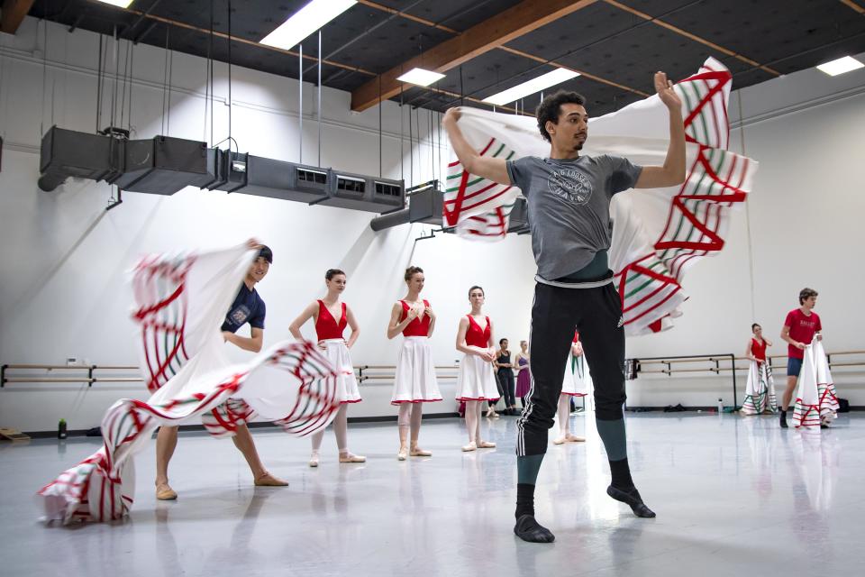 During a rehearsal in a Ballet Arizona studio in Phoenix, Ethan Price and other dancers practice a skirt movement for the upcoming Juan Gabriel production on April 29, 2022.