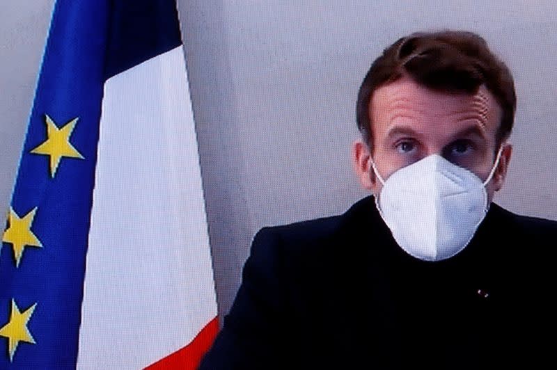 French President Macron, tested positive for coronavirus, is seen on TV screen