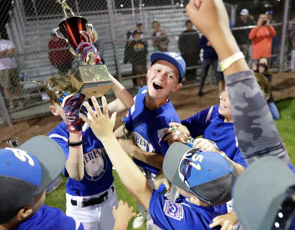 Waverly 51’s Brody Struensee (6) celebrates with teammates following their victory over Pizza King during the Appleton Little League city championship baseball game Wednesday at Scheels USA Youth Sports Complex in Appleton. Waverly 51 defeated Pizza King 9-8 in nine innings.