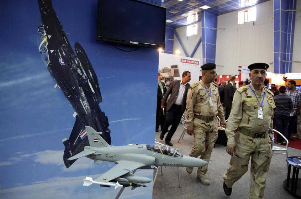 People visit a weapons exhibition organized by the Iraqi defense ministry at the Baghdad International Fairgrounds in Baghdad, Iraq, Saturday, March 1, 2014. Companies from Japan, U.S., Germany, Egypt, China and others displayed armored vehicles, sample models of aircraft and light and medium weaponry. (AP Photo/Karim Kadim)