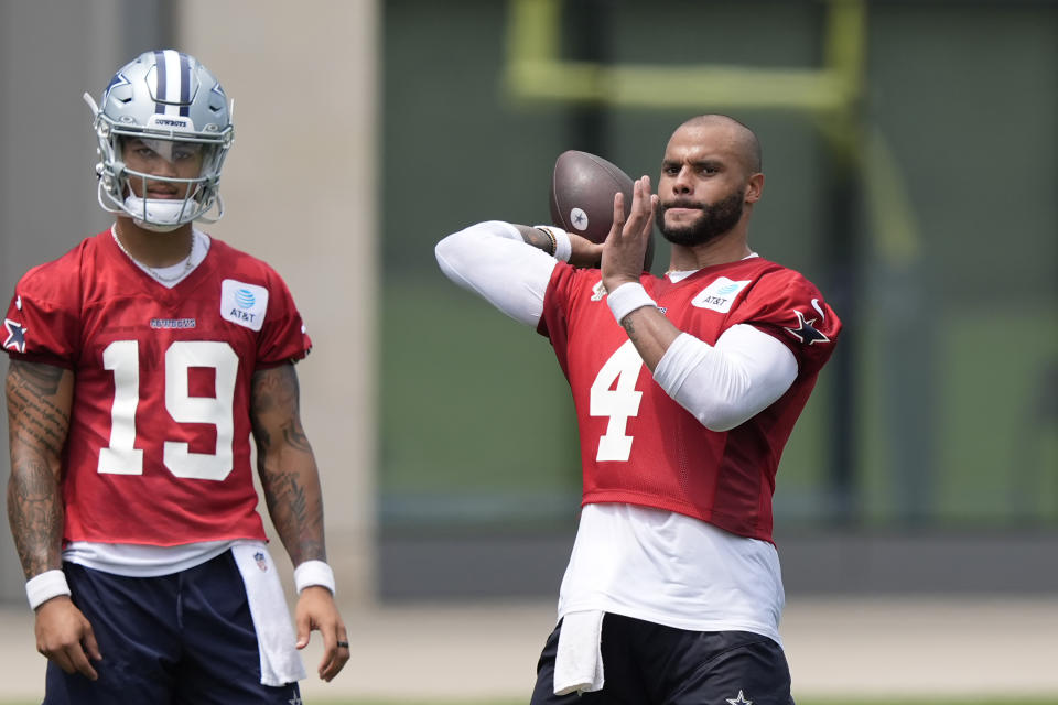 Dallas Cowboys quarterback Dak Prescott (4) passes as backup quarterback Trey Lance (19) looks on during NFL football practice in Frisco, Texas, Wednesday, June 5, 2024. (AP Photo/LM Otero)