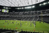 Las Vegas Raiders players warms up during an NFL football training camp practice at Allegiant Stadium, Friday, Aug. 28, 2020, in Las Vegas. (AP Photo/John Locher)