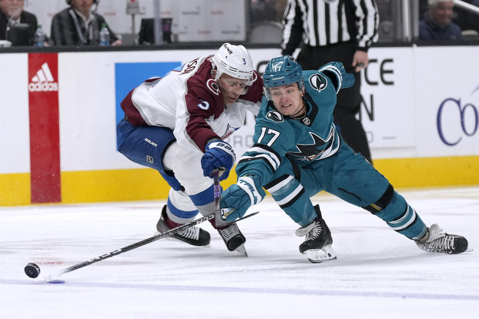 San Jose Sharks center Thomas Bordeleau (17) vies for the puck against Colorado Avalanche defenseman Jack Johnson (3) in the first period of an NHL hockey game Tuesday, April 4, 2023, in San Jose, Calif. (AP Photo/Tony Avelar)