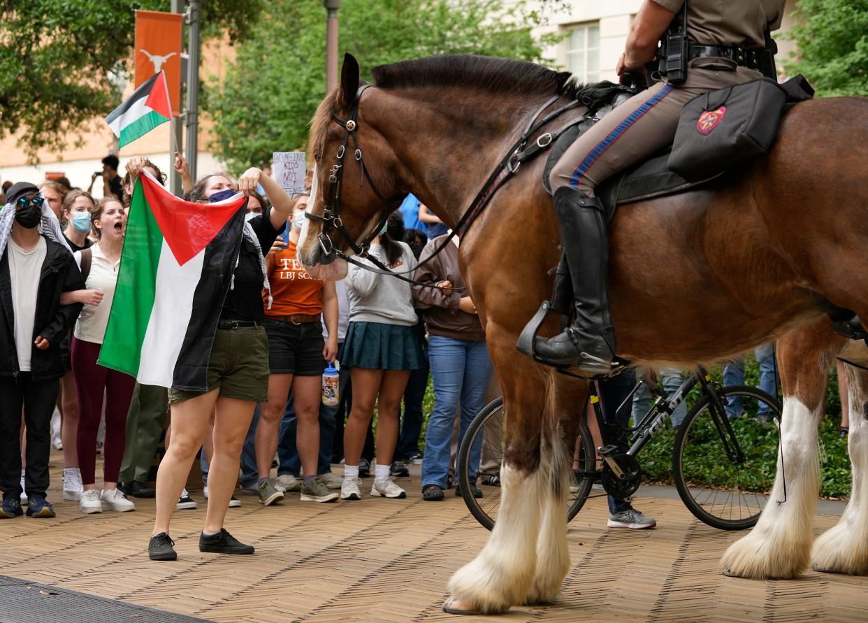 Cally, a former UT student, faces off with a mounted state trooper at a pro-Palestinian protest at the University of Texas Wednesday April 24, 2024.