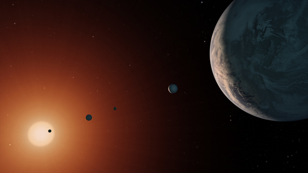An illustration showing what the TRAPPIST-1 system might look like from a vantage point near planet TRAPPIST-1f (right). (NASA/JPL-Caltech)