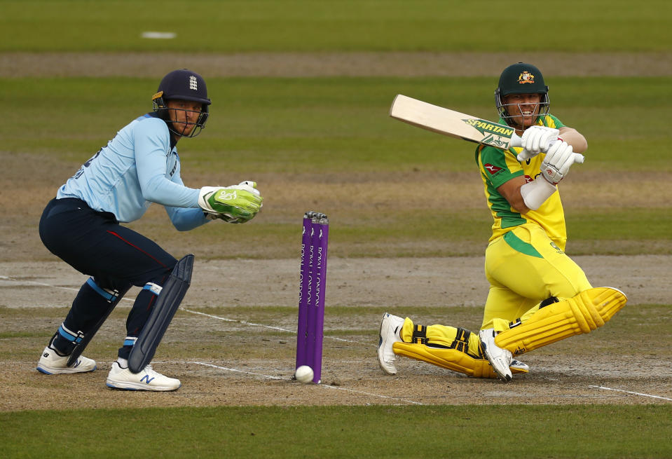 Australia's David Warner, right, plays a shot during the third ODI cricket match between England and Australia, at Old Trafford in Manchester, England, Wednesday, Sept. 16, 2020. (Jason Cairnduff/Pool via AP)