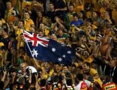 Australia's Tim Cahill (C) and his teammates pose for pictures with fans after they beat South Korea to win the Asian Cup at the Stadium Australia in Sydney January 31, 2015. REUTERS/Edgar Su