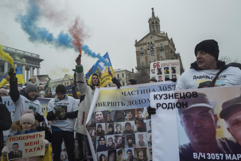 Ukrainians holding pictures of missing soldiers during a demonstration in downtown Kyiv, Ukraine, Saturday Jan. 14, 2023. (AP Photo/Bela Szandelszky)