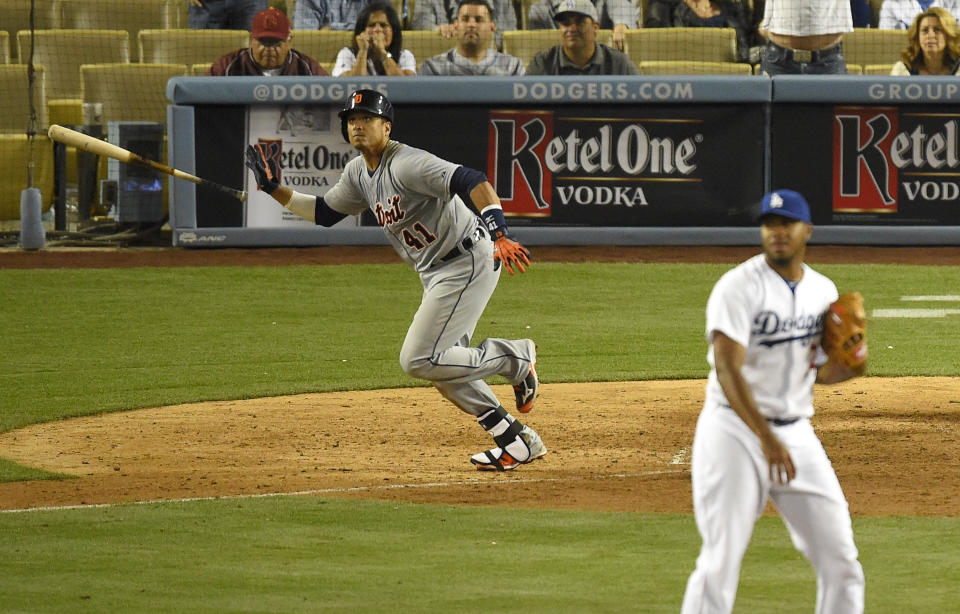 Detroit Tigers' Victor Martinez, left, tosses his bat as he hits a solo home run as Los Angeles Dodgers relief pitcher Kenley Jansen, right, looks on during the 10th inning of a baseball game, Wednesday, April 9, 2014, in Los Angeles. (AP Photo/Mark J. Terrill)