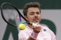 Switzerland's Stan Wawrinka plays a shot against France's Corentin Moutet during their first round match at the French Open tennis tournament in Roland Garros stadium in Paris, France, Monday, May 23, 2022. (AP Photo/Christophe Ena)