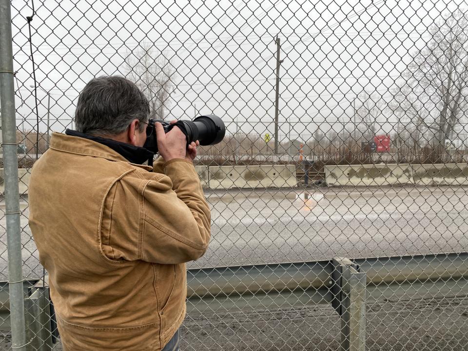 Vincent LaMay of Trenton takes pictures of eagles from an administrative building parking lot during the annual eagle tour Jan. 27 at the DTE Monroe Power Plant. Fog at the viewing area along Lake Erie reduced visibility and photo opportunities during the tour, but some eagles were visible near the plant entrance.