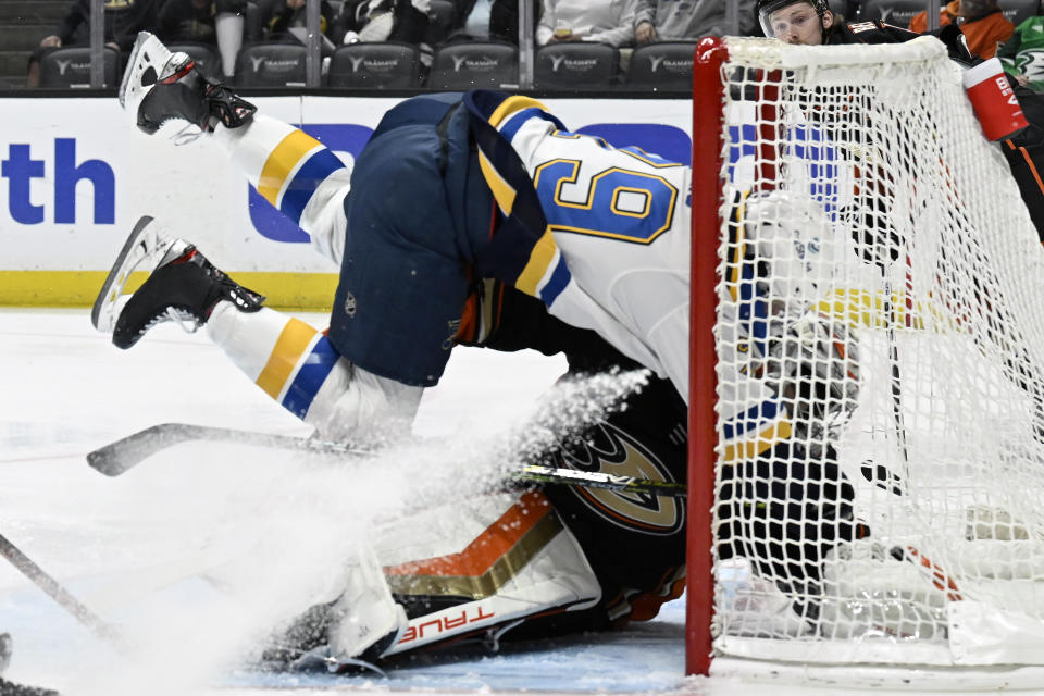 St. Louis Blues left wing Sammy Blais, top, collides into Anaheim Ducks goaltender John Gibson on a shot attempt during the first period of an NHL hockey game in Anaheim, Calif., Saturday, March 25, 2023. (AP Photo/Alex Gallardo)