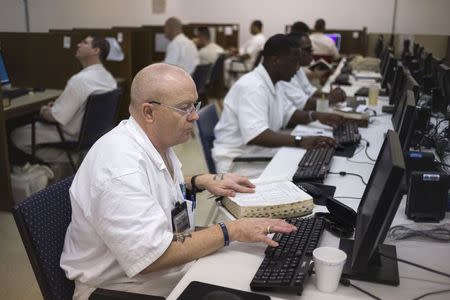 Offenders research and work on their papers inside the Southwestern Baptist Theological computer lab located in the Darrington Unit of the Texas Department of Criminal Justice men's prison in Rosharon, Texas August 12, 2014. REUTERS/Adrees Latif