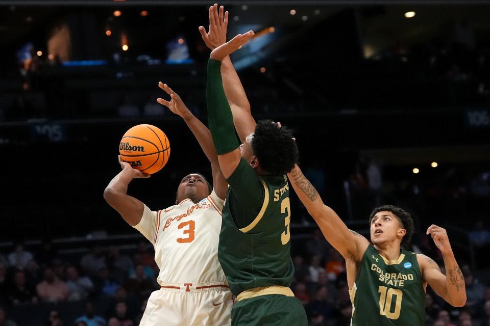 Texas guard Max Abmas gets off a shot while being defended by Colorado State players Josiah Strong and Nique Clifford during Thursday's first-round win. The Longhorns face No. 2-seeded Tennessee in Saturday night's second round of the NCAA Tournament.