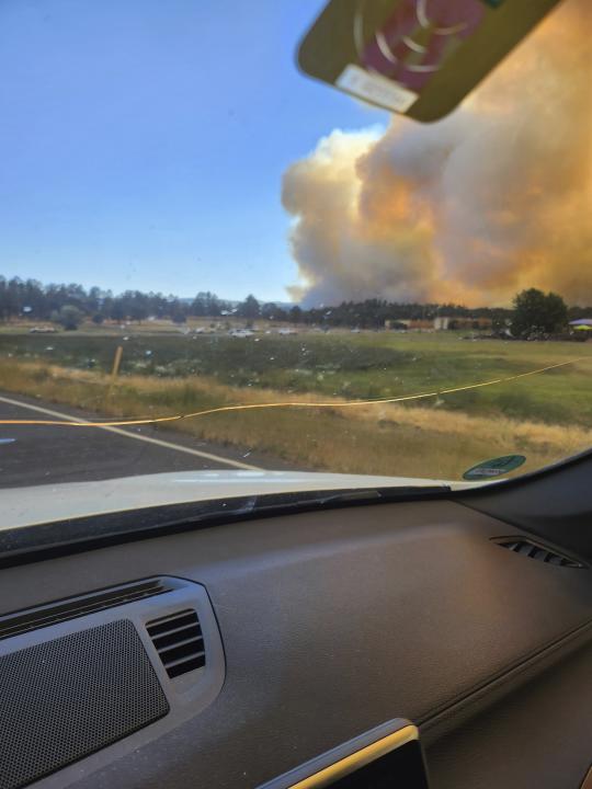 In this photo provided by Belinda Bukovitz, smoke rises from fires in Ruidoso, N.M., Monday, June 17, 2024. Thousands of southern New Mexico residents fled the mountainous village as a wind-whipped wildfire tore through homes and other buildings. (Belinda Bukovitz via AP)