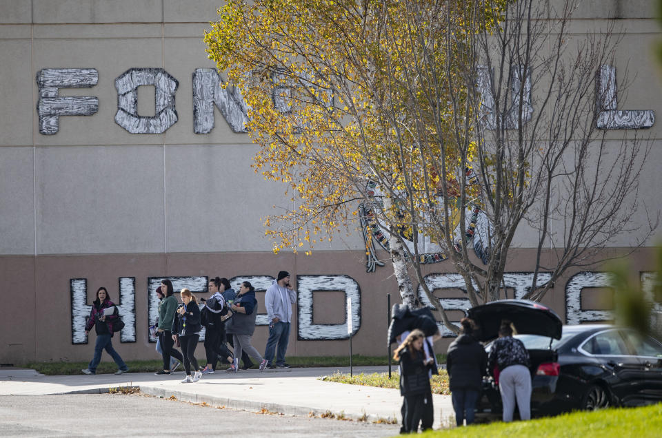 People walked away from the community center on the Fond Du Lac Band reservation near Cloquet, Minn., Friday, Oct. 18, 2019, after the lockdown was lifted. One man was shot and a suspect was arrested after a shooting Friday on an American Indian reservation in northern Minnesota that prompted a lockdown of tribal offices and a school. (Alex Kormann/Star Tribune via AP)