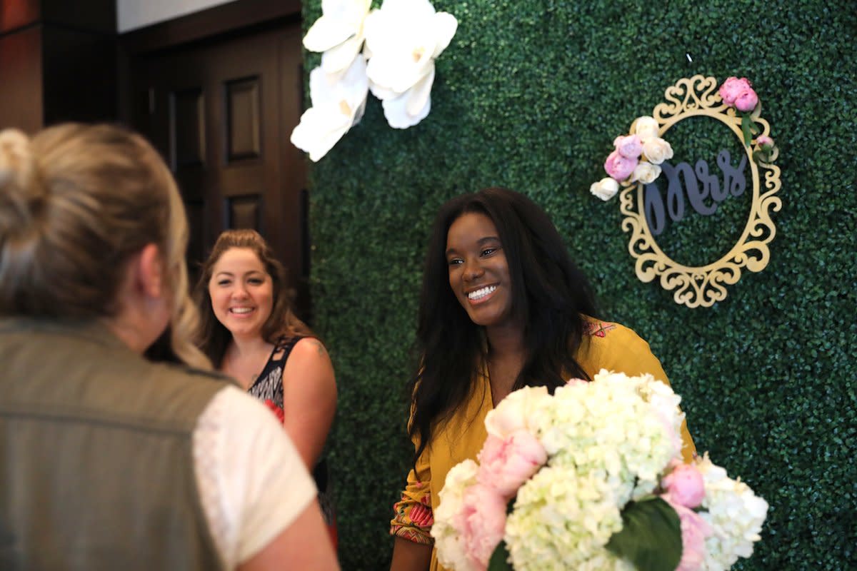 Wedding planner discussing her business at a bridal expo.