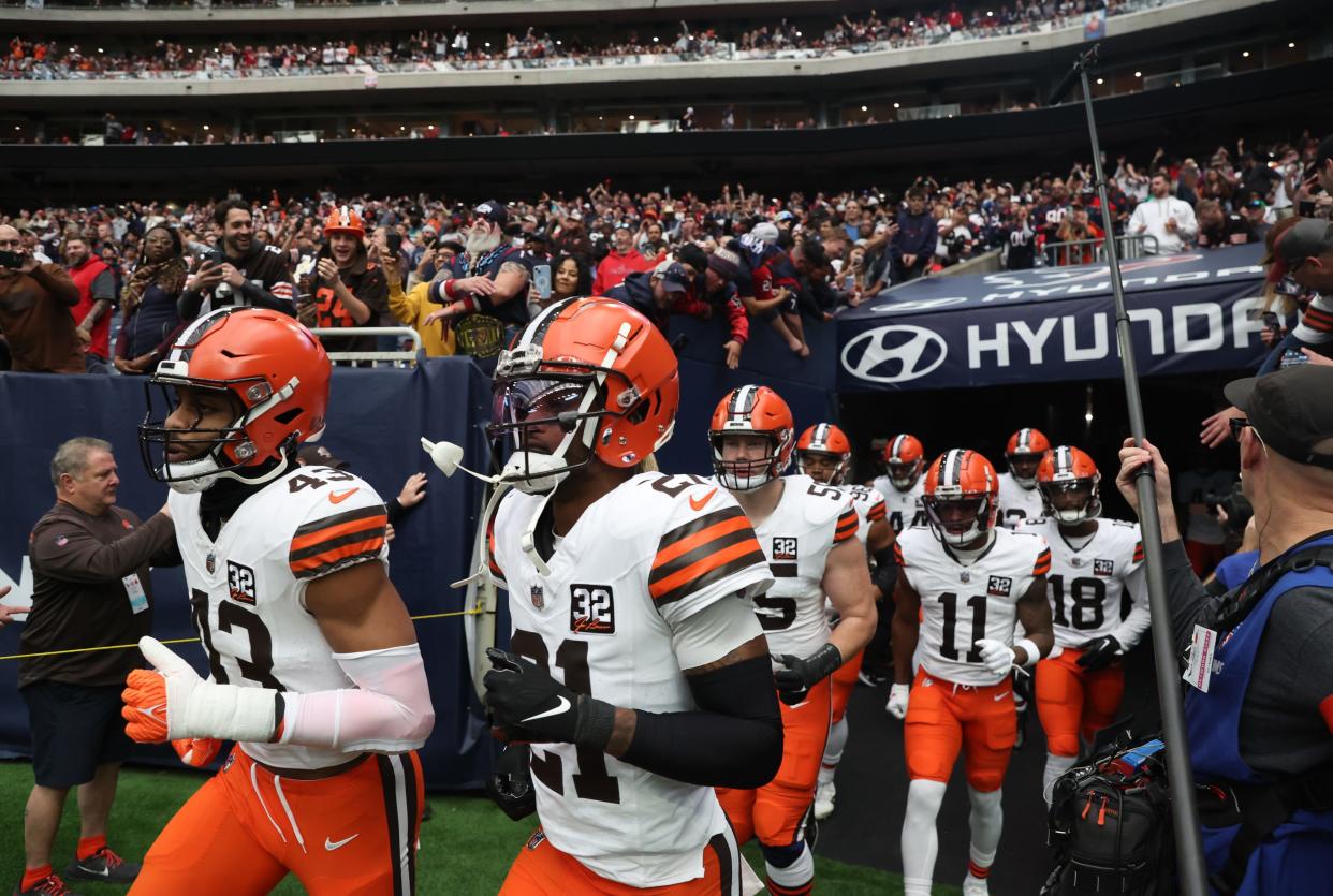 Browns linebacker Mohamoud Diabate (43) and cornerback Denzel Ward (21) lead their team onto the field before playing at the Houston Texans in an AFC wild card game, Jan. 13, 2024.