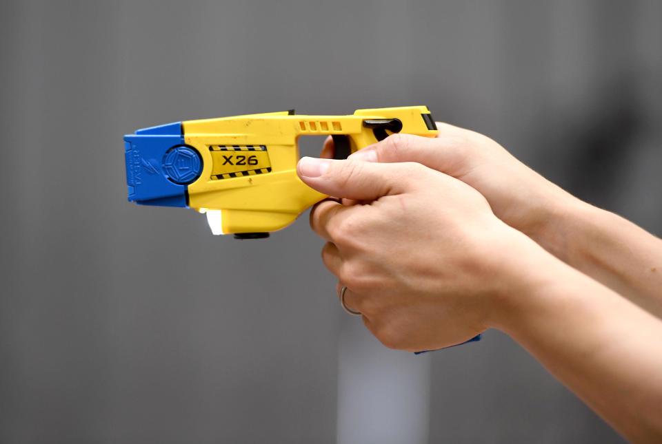 Taser, police officer using a taser during training. The focus of the event is to demonstrate the transparency around Dorset Police's use of force and the challenges involved, along with an overview of equipment and the skills that improve public and officer safety.  This comes ahead of the publication of use of force data by individual police forces nationally at the end of July. An officer demonstrates using an X26 Taser Credit: Finnbarr Webster/Alamy Live News