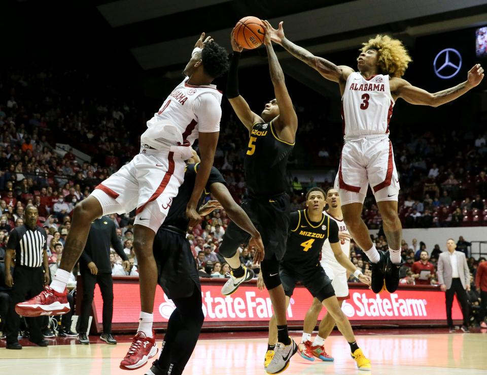 Missouri guard Jarron Coleman (5) grabs a rebound between Alabama forward Noah Gurley (0) and Alabama guard JD Davison (3) in Coleman Coliseum Saturday, Jan. 22, 2022. 