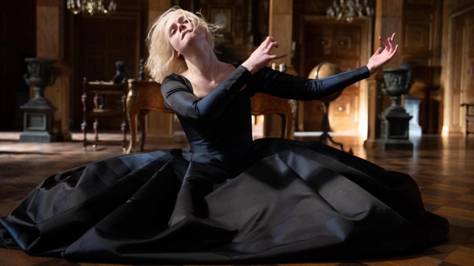 Elle Fanning on her knees dancing in The Great.