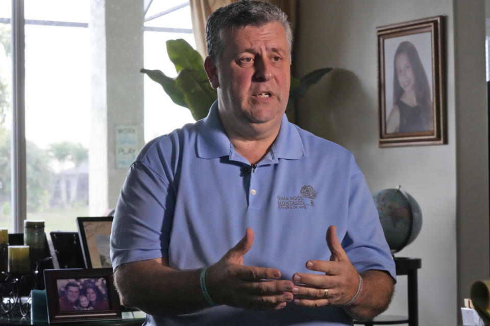 Surrounded by photos of his daughter, Gina Rose Montalto, Tony Montalto speaks during an interview, Friday, Feb. 3, 2023, at the family home in Parkland, Fla. Gina was one of the victims of Parkland's Marjory Stoneman Douglas High School shooting five years ago. Her parents, Tony and Jennifer, set up the Gina Rose Montalto Memorial Foundation, to help dozens of college students and others. (AP Photo/Wilfredo Lee)