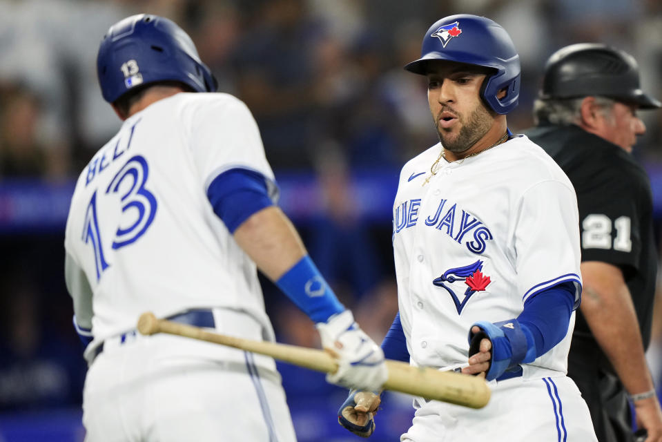 Toronto Blue Jays' George Springer, right, celebrates with Brandon Belt after scoring against the San Francisco Giants during the first inning of a baseball game Wednesday, June 28, 2023, in Toronto. (Frank Gunn/The Canadian Press via AP)