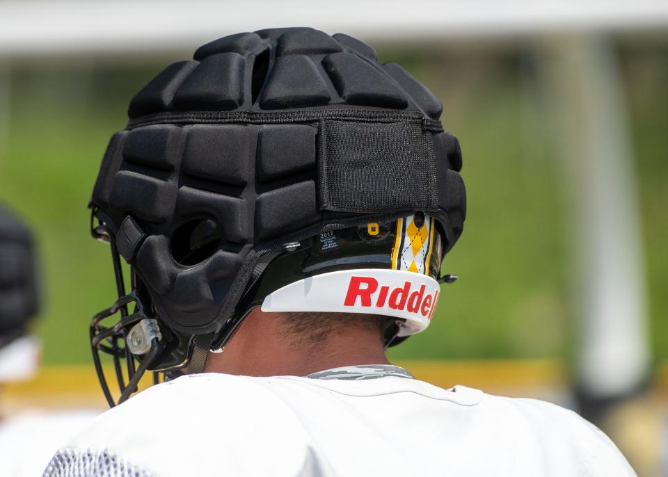 Red Lion linemen and running backs are wearing Guardian Caps over their helmets during practice to reduce impact.